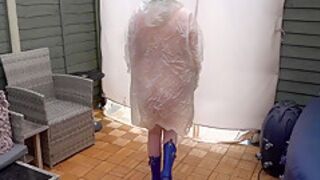 Under Plastic Transparent Raincoat And Wellingtons Out In The Cold Outdoors